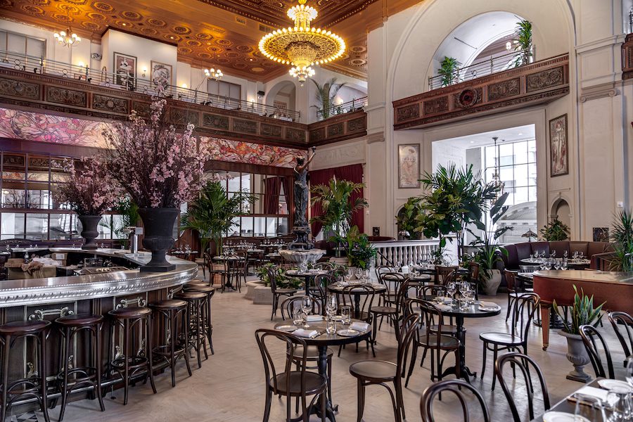 la grande boucherie dc art nouveau french brasserie steakhouse mezzanine courtyard gilded ceiling with chandelier and plants